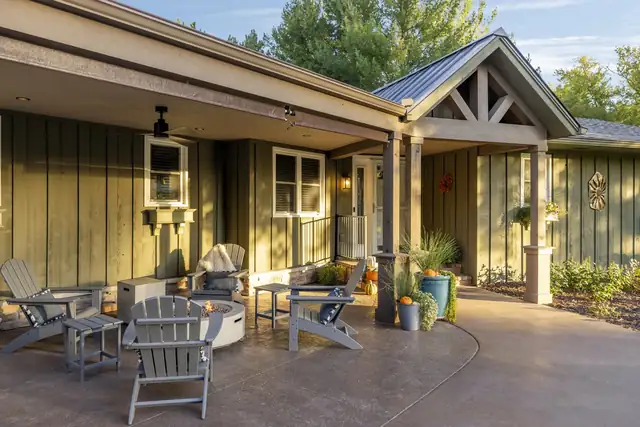 Inver Grove Heights exterior renovation with a covered patio, gabled roof, board-and-batten siding and outdoor seating